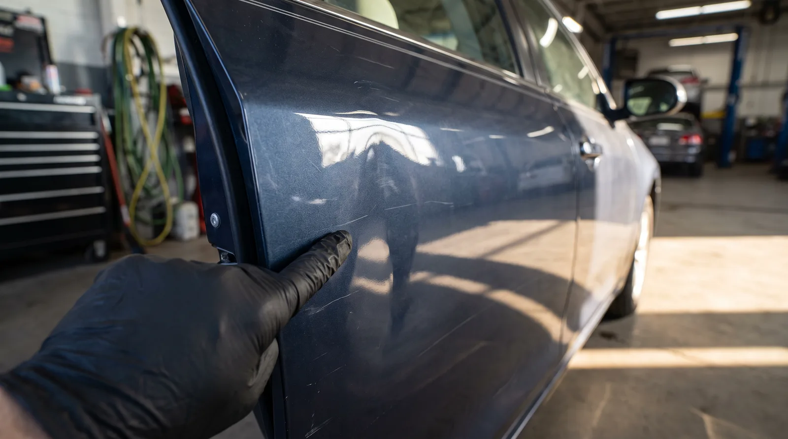 Close-up of a dent on a car door